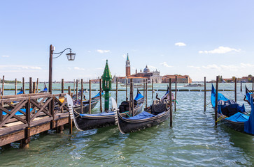Fototapeta na wymiar Water channels of Venice city. Parking gondolas near St. Mark Square on Grand Canal in Venice, Italy.
