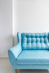 blue sofa on a white background in the interior