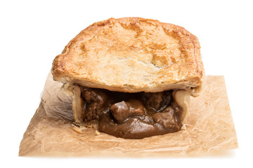 Homemade flaky pasty with steak and ale gravy filling isolated on white