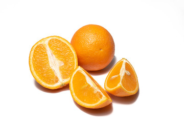 Oranges on white background. Pieces of oranges and whole oranges, with little shadow. Groups of oranges on white