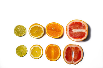 Slices and halves of lemon, lime, orange and grapefruit on a white background. Multiple kinds of citric together.  