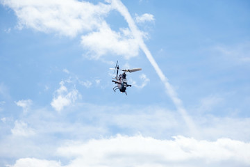 Fototapeta na wymiar military assault helicopter performs acrobatics at an air show