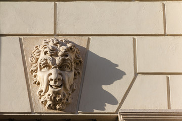A mask (a sculpture depicting a fantasy human face) that reproduces the severed head of Gorgon, the figure of Greek mythology. The sculpture is placed above the door of an ancient building in Vicenza.