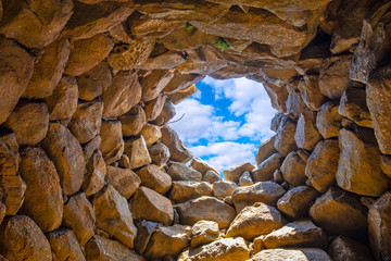 Arzachena, Sardinia, Italy - Archeological ruins of Nuragic complex La Prisgiona - Nuraghe La Prisgiona - with interior of stone tower of Neolithic fortress
