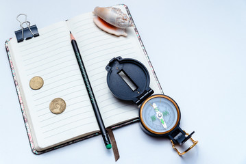 Open notebook, pencil and compass on a white background