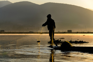 Fisher and his catch on Inle Lake, Myanmar