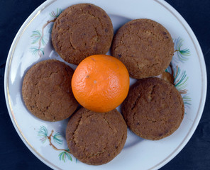 
biscuit cookies and mandarin duck lie on a plate