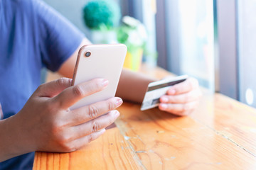 Woman hands holding credit card and smartphone ,Online shopping
