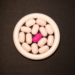 Pharmaceutical medicine tablets on a black background.