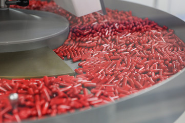 red pills and laboratory equipment in pharmaceutical industry