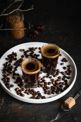 Espresso coffee in two glasses. Dark background. Dark style