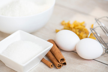 Obraz na płótnie Canvas Ingredients for cake baking. Flour, sugar, eggs and cinnamon sticks.