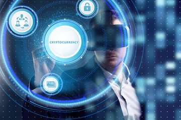 Business, Technology, Internet and network concept. Young businessman working on a virtual screen of the future and sees the inscription: Cryptocurrency