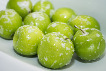 .Washing fruit. Soapy green apples in the sink. Washing fruits and vegetables for the prevention of coronavirus covid-19 2019-ncov