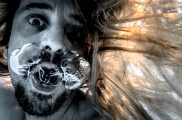 Artistic pic out of focus underwater with long hair man swimming with bubble in water, dark underwater atmosphere with nightmare human abyssal creature like mermaid with beard