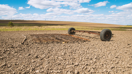 harrow on a plowed field in spring