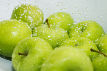Washing fruit. Wet apples in the shower. Girl washes fruits and vegetables for the prevention of coronavirus covid-19 2019-ncov