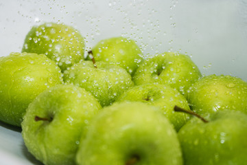 Washing fruit. Wet apples in the shower. Girl washes fruits and vegetables for the prevention of coronavirus covid-19 2019-ncov