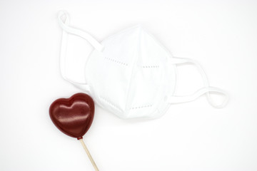 Medical mask on a white background. red heart. Coronavirus Protection Concept