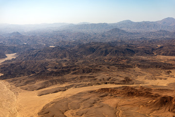 Aerial view of the Sahara desert between the river Nile and the Red Sea, seen from the airplane window. Egypt, Africa