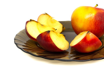 yellow red tasty fresh cut sliced half apple on glass plate