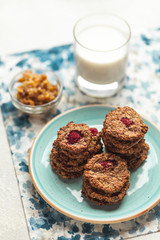 Whole grain vegetarian oatmeal cookies with a glass of milk for breakfast. Healthy lifestyle, homemade cakes.