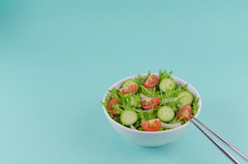 Salad in a bowl with chopsticks