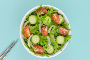 Salad in a bowl with chopsticks