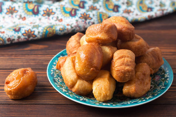 baursaki in a plate with a national pattern, Bashkir dishes, Uzbek dishes, oriental cuisine