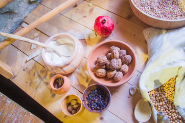 Fototapeta na wymiar ancient country cuisine, traditional cuisine, ingredients, agricultural and hunting products, walnuts, pesto, juniper berries, cinnamon, pomegranate and flour