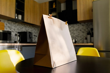 Paper bag with food on table at modern kitchen