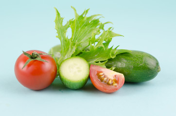 Sliced tomato and cucumber with lettuce. Ingredients of salad dish