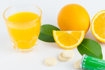 Healthy concept image. vitamin C supplement: fresh orange, orange juice, and effervescent tablet vitamin C.