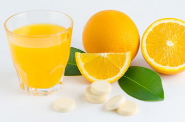 Healthy concept image. vitamin C supplement: fresh orange, orange juice, and effervescent tablet vitamin C.