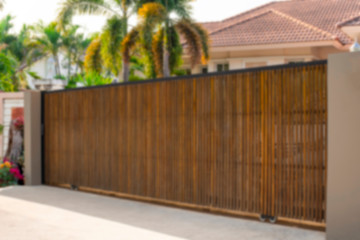 Electric automatic wooden door or garage with modern home background. Auto gate and remote control...
