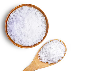 Closeup coarse or rock natural sea salt in brown spoon isolated on white background. Clipping path....