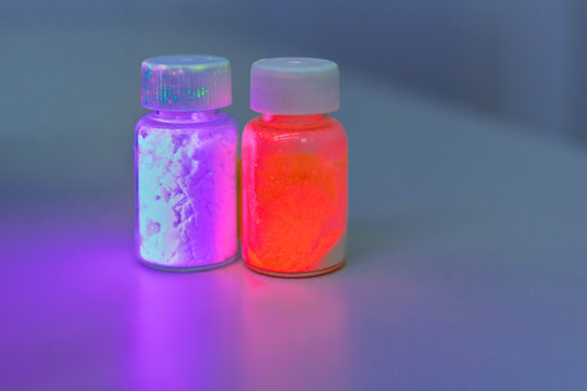 Photoluminescence Chemical Materials, Called Fluorescent. Powder Glows In The Dark Under UV Light Radiation Of Different Colors.