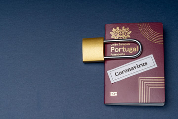 Portuguese european travel passport with padlock on blue background.