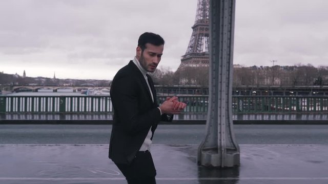 fashionable guy walking on a eiffel tower background