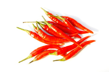 In the photo, red  chili peppers.  Pods on a white background.