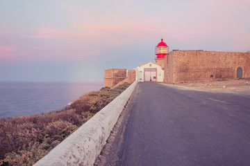 View of the lighthouse and cliffs at Cape St. Vincent at sunset. Continental Europe's most...
