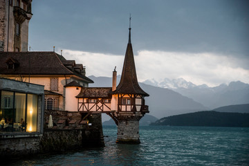 an old castle over the water at dusk in the Swiss Alps