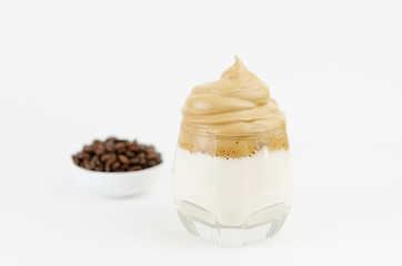 Dalgona frothy coffee trend Korean drink latte espresso with coffee foam on black background