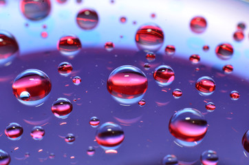 shiny clear water point attached to a glass reflects the same color as the color on the glass into a beautiful background as decoration