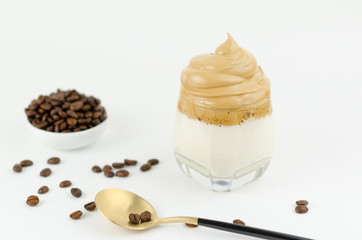 Dalgona frothy coffee trend Korean drink latte espresso with coffee foam on black background