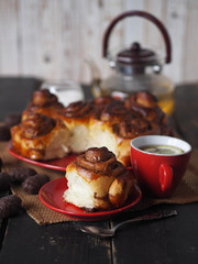 Holiday tea party.Freshly baked rolls with chocolate filling and a Cup of tea with lemon on an ancient wooden table.