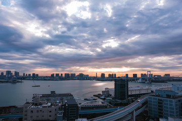 Fototapeta na wymiar Scenic cityscape view in tokyo japan with beautiful dramatic sky and sunlight through clouds at sunrise time in the morning.