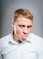 Obraz premium young man shows tongue