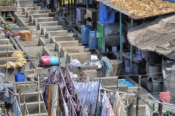 Mumbai, India-March 03,2013: Laundry Dhobi Ghat in Mumbai, people wash clothes on a city street. India's biggest wash.