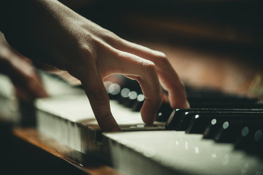 hand on piano keys close-up
